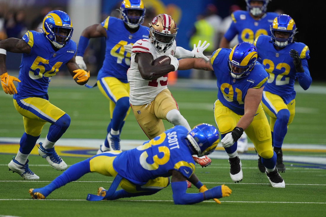 Jan 30, 2022; Inglewood, California, USA; San Francisco 49ers wide receiver Deebo Samuel (19) is pursued by Los Angeles Rams outside linebacker Leonard Floyd (54) and defensive end Earnest Brown IV (90) on a 44-yard touchdown reception in the second quarter during the NFC Championship game at SoFi Stadium. The Rams defeated the 49ers 20-17. Mandatory Credit: Kirby Lee-USA TODAY Sports