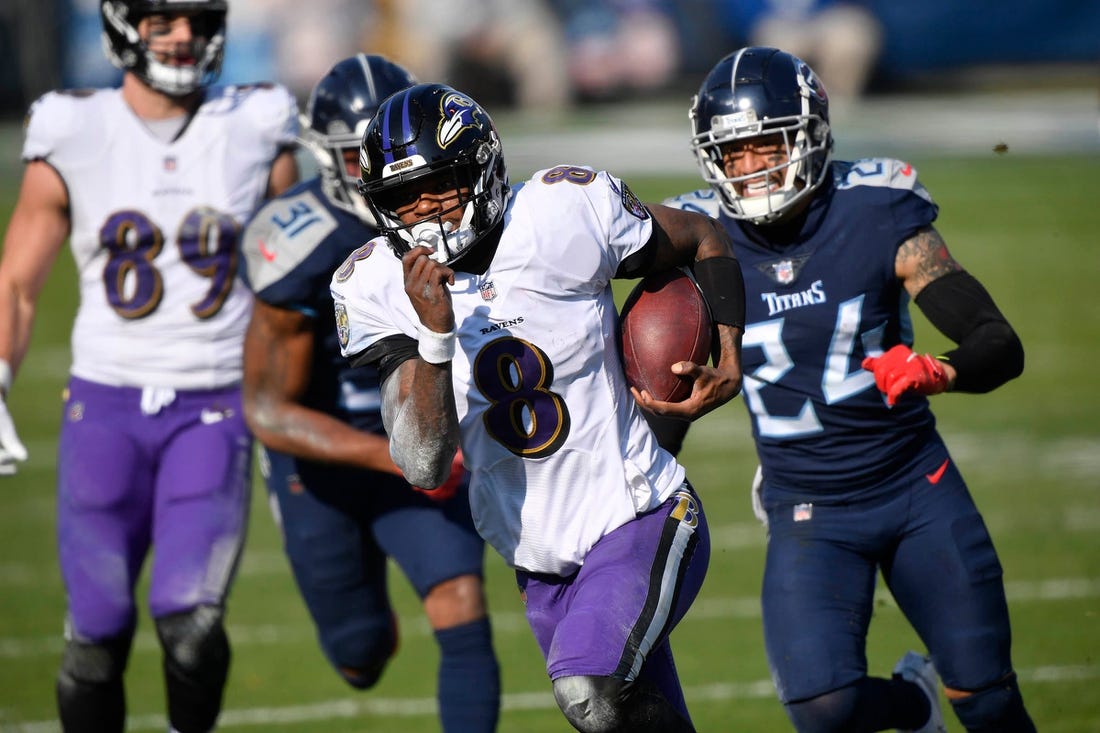 Baltimore Ravens quarterback Lamar Jackson (8) runs for a touchdown during their 20-13 victory over the Tennessee Titans in the AFC Wild Card game at Nissan Stadium in Nashville Jan. 10, 2021.

Titans Ravens 111