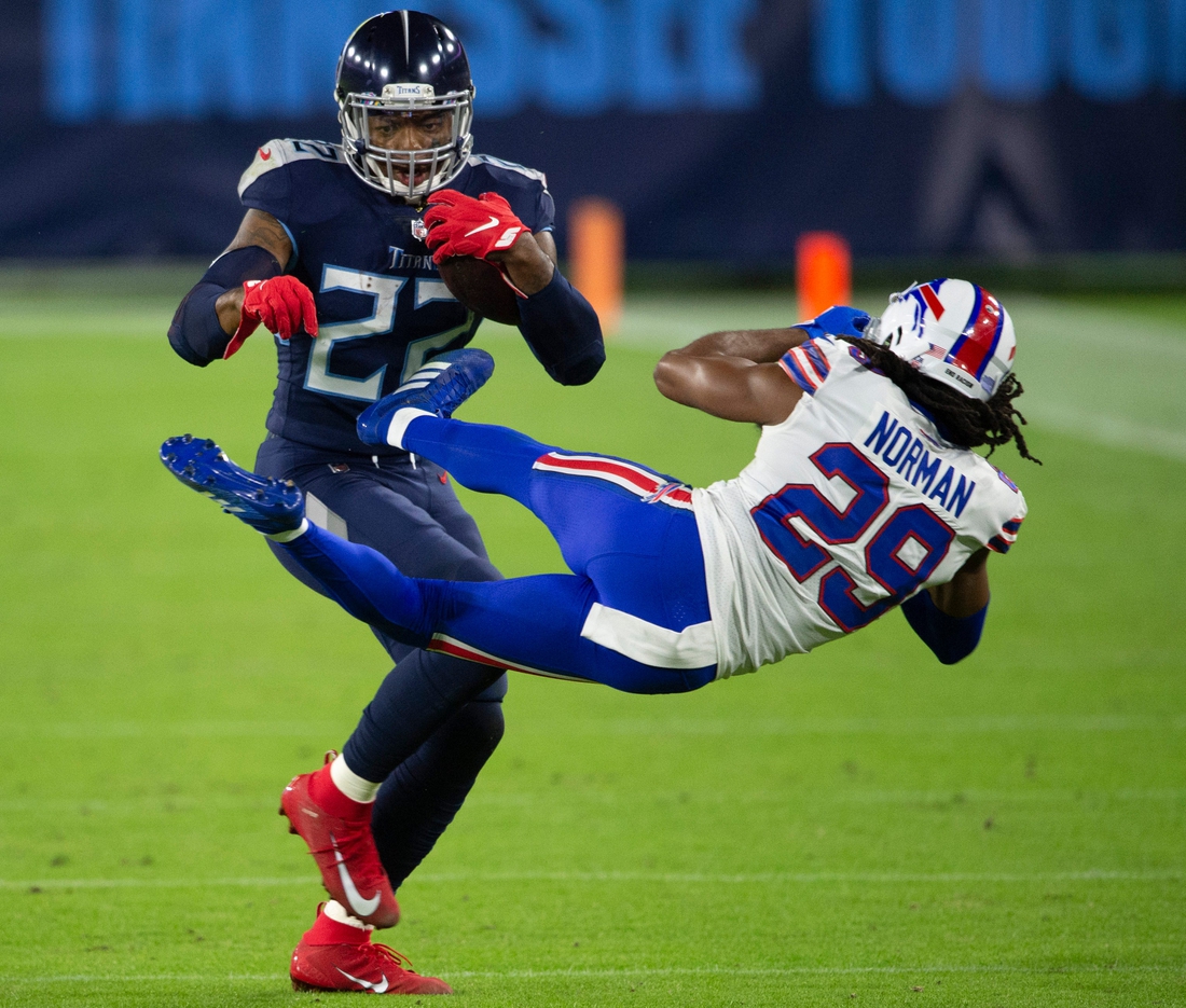 Tennessee Titans running back Derrick Henry (22) throws Buffalo Bills cornerback Josh Norman (29) aside as he rushes up the field during the second quarter at Nissan Stadium Tuesday, Oct. 13, 2020 in Nashville, Tenn.Nas Titans Bills 001