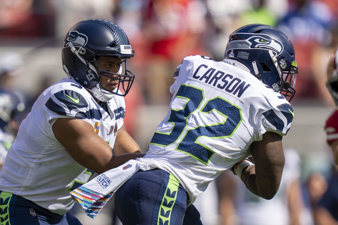 October 3, 2021; Santa Clara, California, USA; Seattle Seahawks quarterback Russell Wilson (3) hands the football off to running back Chris Carson (32) against the San Francisco 49ers during the first quarter at Levi's Stadium. Mandatory Credit: Kyle Terada-USA TODAY Sports
