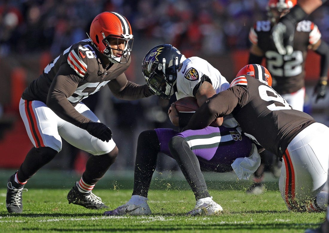 Ravens quarterback Lamar Jackson is brought down by Browns defensive end Myles Garrett (right) during the first half Sunday, Dec. 12, 2021, in Cleveland.

Browns 14