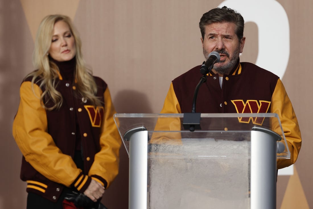 Feb 2, 2022; Landover, MD, USA; Washington Commanders co-owner Dan Snyder speaks as co-owner Tanya Snyder (L) listens during a press conference revealing the Commanders as the new name for the formerly named Washington Football Team at FedEx Field. Mandatory Credit: Geoff Burke-USA TODAY Sports