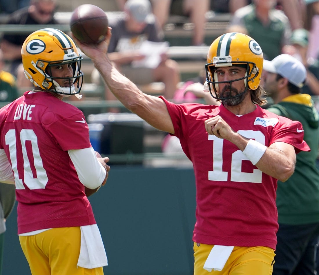 Aaron Rodgers (12) makes a throw while Jordan Love (10) looks on during Green Bay Packers minicamp Tuesday, June 7, 2022 in Green Bay, Wis.

Packers08 1
