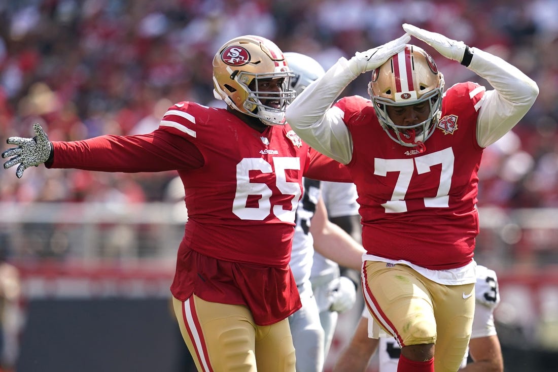 Aug 29, 2021; Santa Clara, California, USA; San Francisco 49ers offensive tackle Alfredo Gutierrez (77) celebrates next to defensive lineman Darrion Daniels (65) after making a tackle against the Las Vegas Raiders in the third quarter at Levi's Stadium. Mandatory Credit: Cary Edmondson-USA TODAY Sports