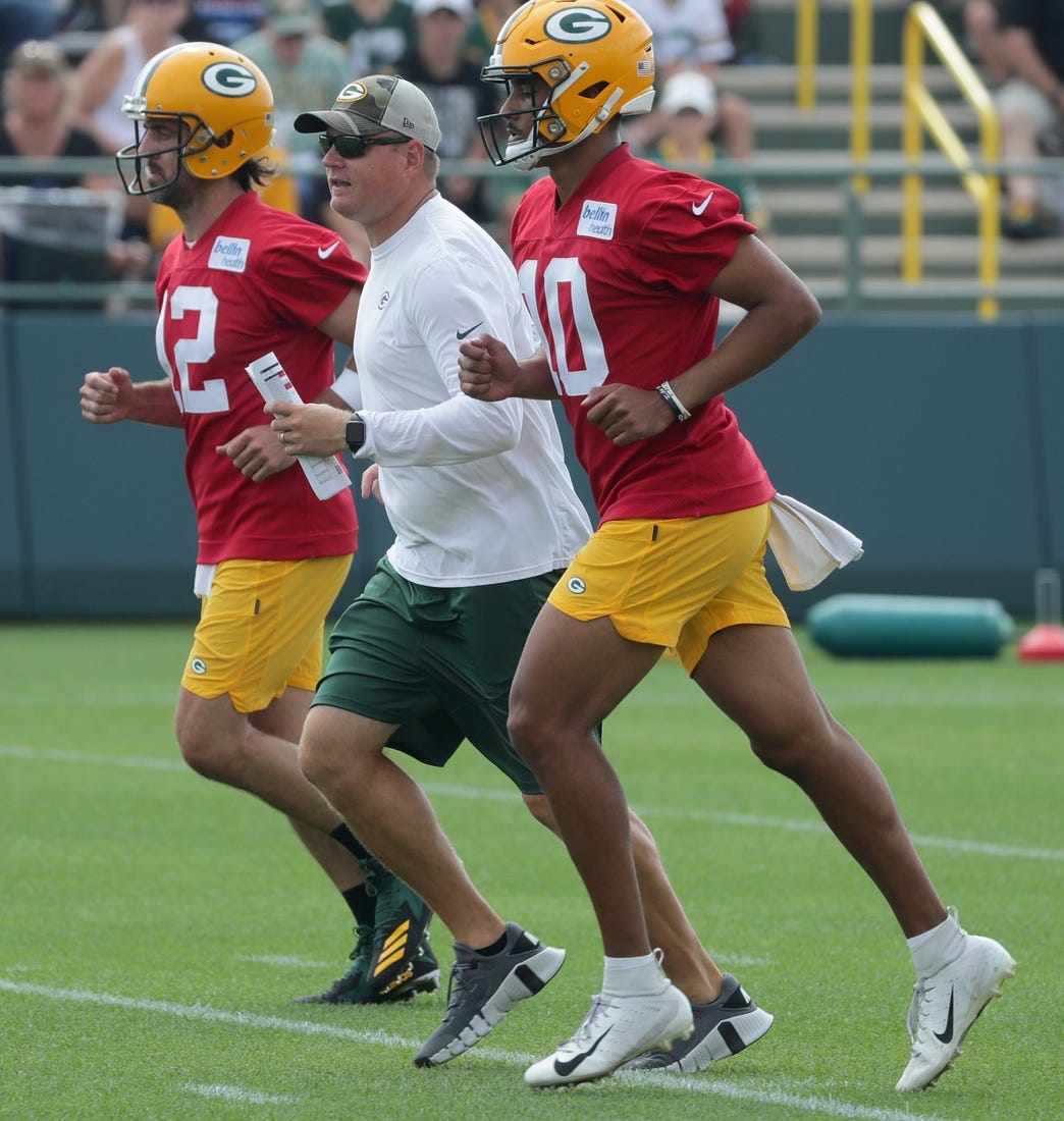 Green Bay Packers quarterbacks coach Luke Getsy runs between quarterback Aaron Rodgers (12) and quarterback Jordan Love (10) during the second day of training camp Thursday, July 29, 2021 in Green Bay, Wis.

Mjs Packers30 29 Jpg Packers30