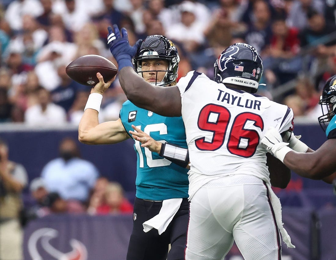 Sep 12, 2021; Houston, Texas, USA; Jacksonville Jaguars quarterback Trevor Lawrence (16) attempts a pass as Houston Texans defensive tackle Vincent Taylor (96) defends during the game at NRG Stadium. Mandatory Credit: Troy Taormina-USA TODAY Sports