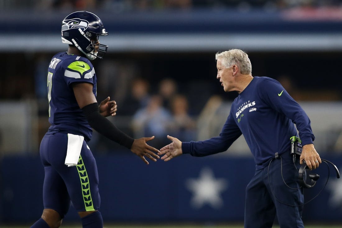 Aug 26, 2022; Arlington, Texas, USA; Seattle Seahawks head coach Pete Carroll (right) congratulates quarterback Geno Smith (7) as he comes off  the field in the first quarter against the Dallas Cowboys at AT&T Stadium. Mandatory Credit: Tim Heitman-USA TODAY Sports