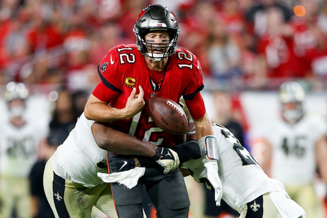 Dec 19, 2021; Tampa, Florida, USA; Tampa Bay Buccaneers quarterback Tom Brady (12) fumbles the ball in the second half against the New Orleans Saints at Raymond James Stadium. Mandatory Credit: Nathan Ray Seebeck-USA TODAY Sports
