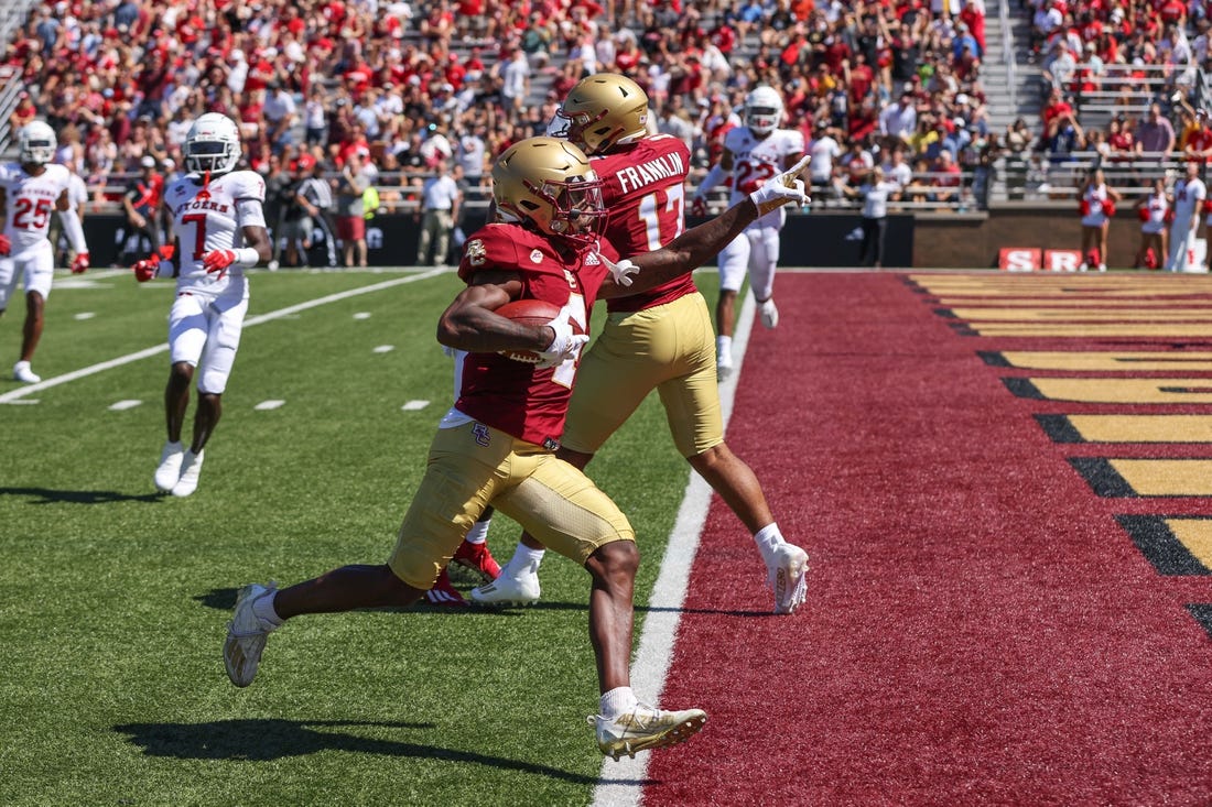 Sep 3, 2022; Chestnut Hill, Massachusetts, USA; Boston College Eagles receiver Zay Flowers (4) scores a touchdown during the first half against the Rutgers Scarlet Knights at Alumni Stadium. Mandatory Credit: Paul Rutherford-USA TODAY Sports