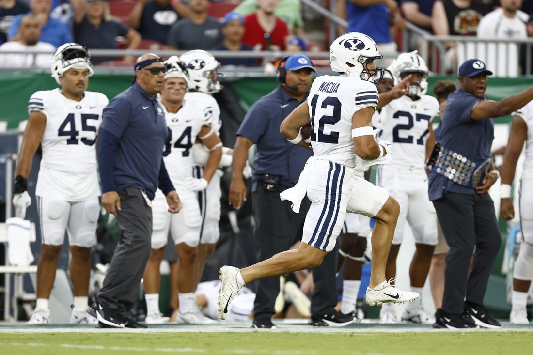 Sep 3, 2022; Tampa, Florida, USA; Brigham Young Cougars wide receiver Puka Nacua (12) runs the ball in for a touchdown against the South Florida Bulls during the first half at Raymond James Stadium. Mandatory Credit: Douglas DeFelice-USA TODAY Sports