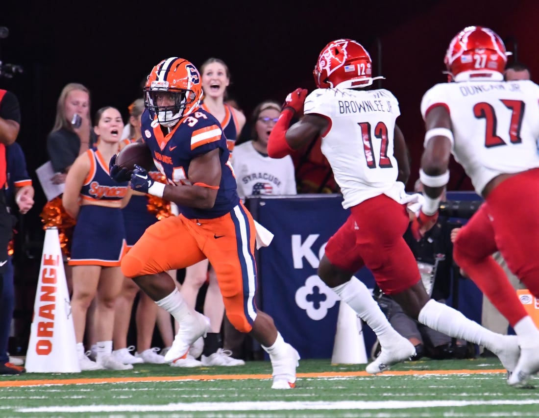 Sep 3, 2022; Syracuse, New York, USA; Syracuse Orange running back Sean Tucker (34) runs against Louisville Cardinals cornerback Jarvis Brownlee (12) in the first quarter at JMA Wireless Dome. Mandatory Credit: Mark Konezny-USA TODAY Sports