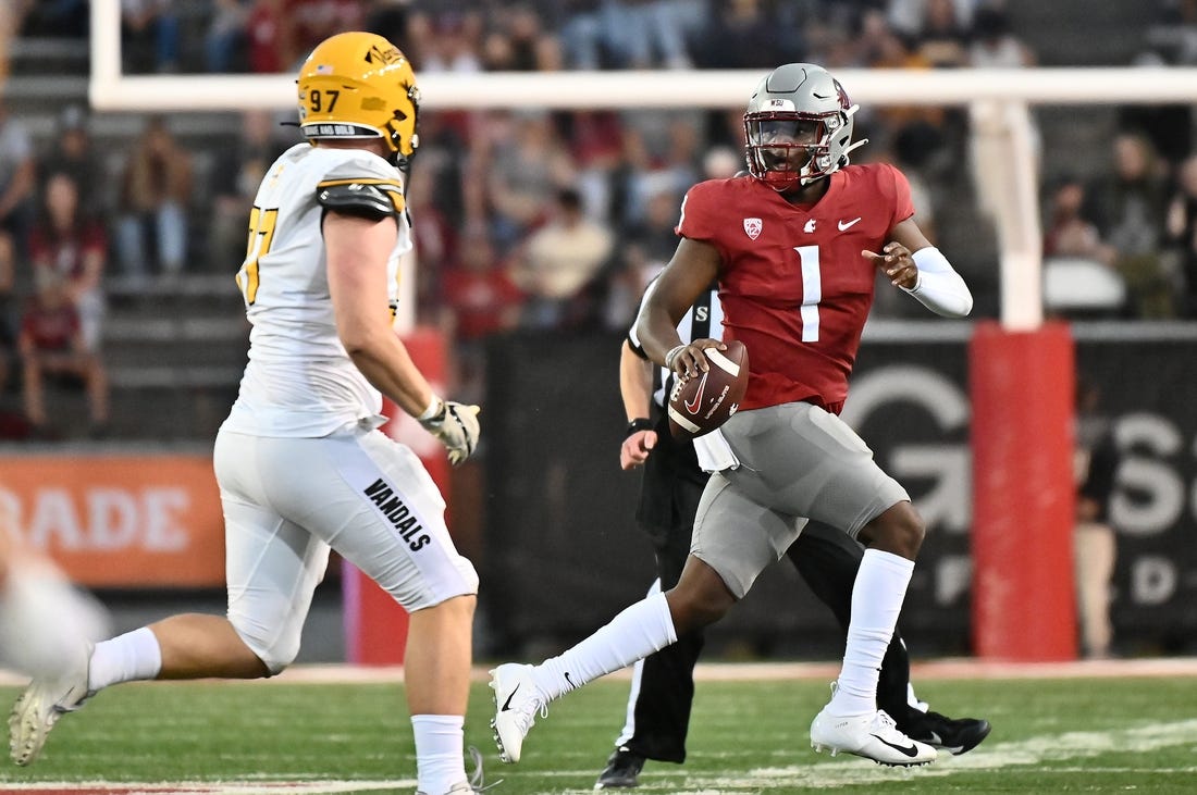 Sep 3, 2022; Pullman, Washington, USA; Washington State Cougars quarterback Cameron Ward (1) is forced out of the pocket by Idaho Vandals defensive lineman Zach Krotzer (96) in the first half at Gesa Field at Martin Stadium. Mandatory Credit: James Snook-USA TODAY Sports