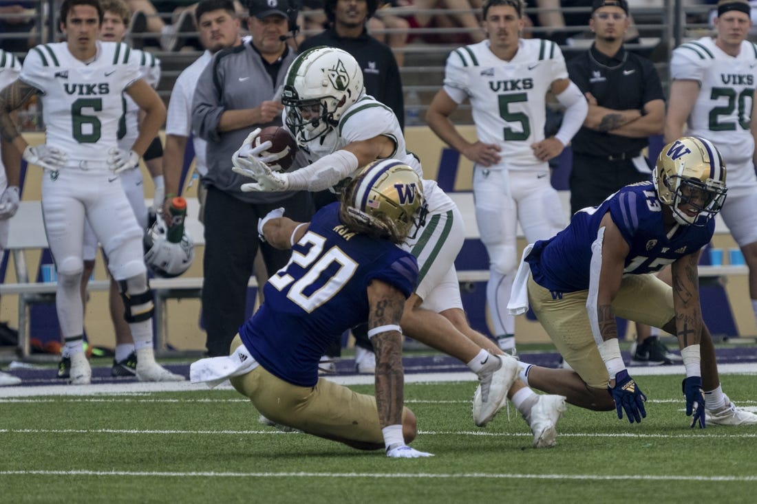 Sep 10, 2022; Seattle, Washington, USA; Portland State Vikings wide receiver Beau Kelly (13) escapes the grasp of Washington Huskies defensive back Asa Turner (20) and linebacker Kamren Fabiculanan (13) after a reception during the first half at Alaska Airlines Field at Husky Stadium. Mandatory Credit: Stephen Brashear-USA TODAY Sports