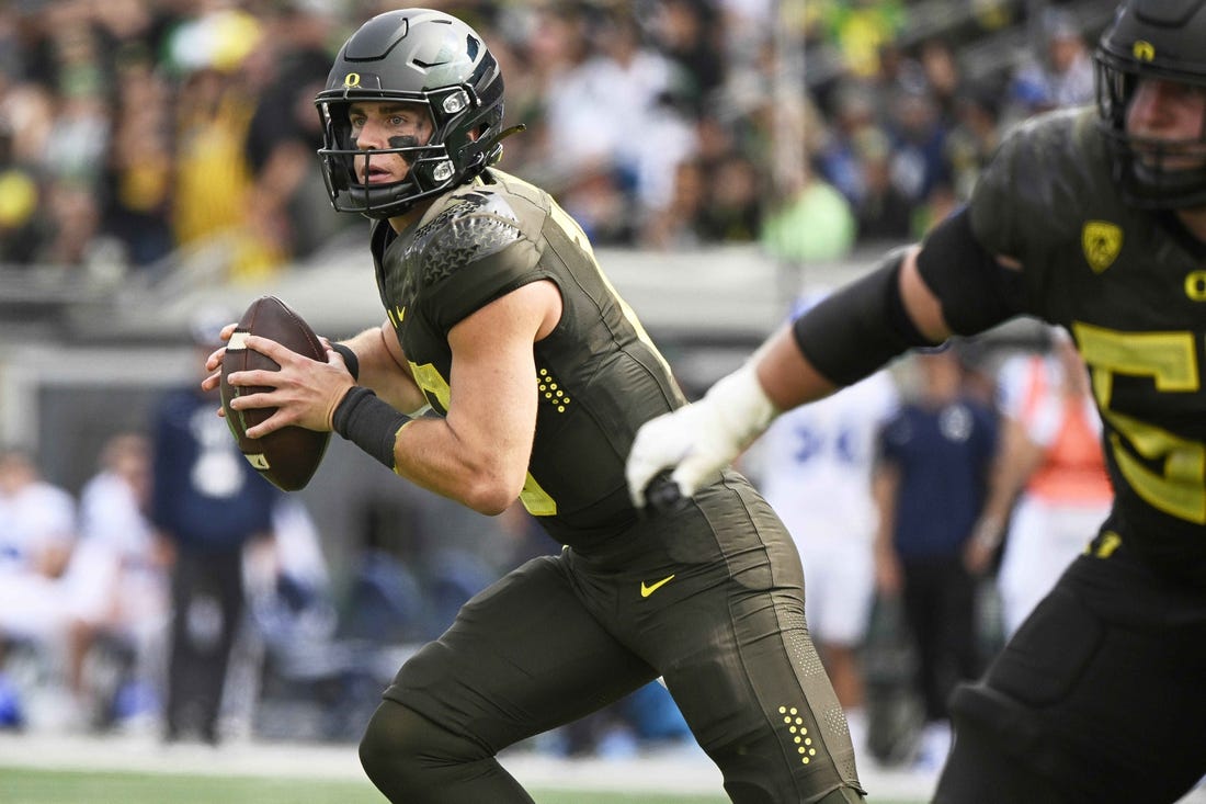 Sep 17, 2022; Eugene, Oregon, USA;  Oregon Ducks quarterback Bo Nix (10) rolls out to pass the ball during the second half against the Brigham Young Cougars at Autzen Stadium. Oregon won the game 41-20. Mandatory Credit: Troy Wayrynen-USA TODAY Sports