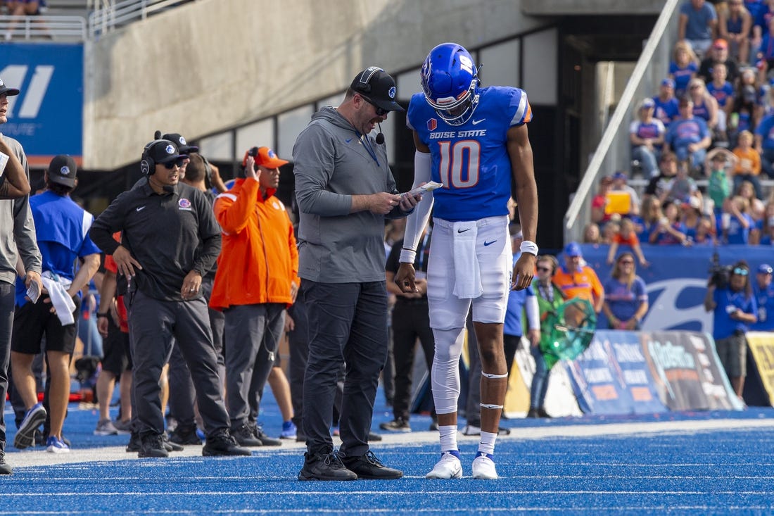 Sep 17, 2022; Boise, Idaho, USA; Boise State Broncos quarterback Taylen Green (10) confers with Boise State offensive coordinator Tim Plough during the second half of action  at Albertsons Stadium versus Tennessee Martin Skyhawks . Boise State defeats Tennessee Martin 30-7. Mandatory Credit: Brian Losness-USA TODAY Sports