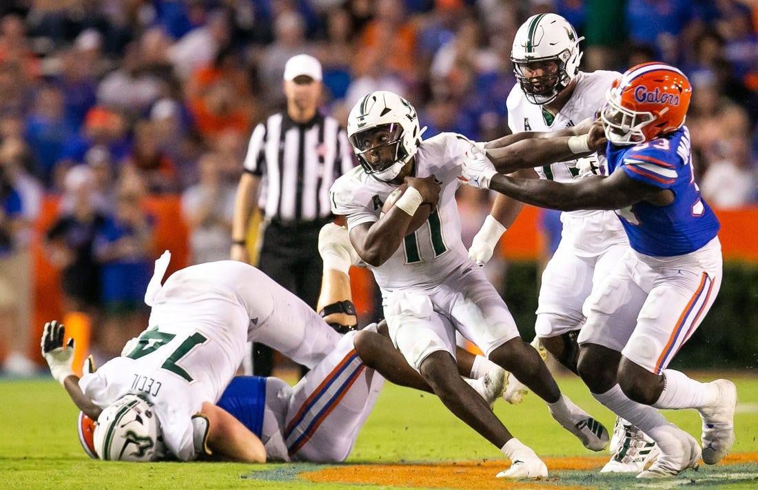 South Florida Bulls quarterback Gerry Bohanon (11) tries to elude Florida Gators in the second half against the Bulls at Steve Spurrier Field at Ben Hill Griffin Stadium in Gainesville, FL on Saturday, September 17, 2022. Florida won 31-28 [Doug Engle/Gainesville Sun]

Ncaa Football Florida Gators Vs Usf Bulls