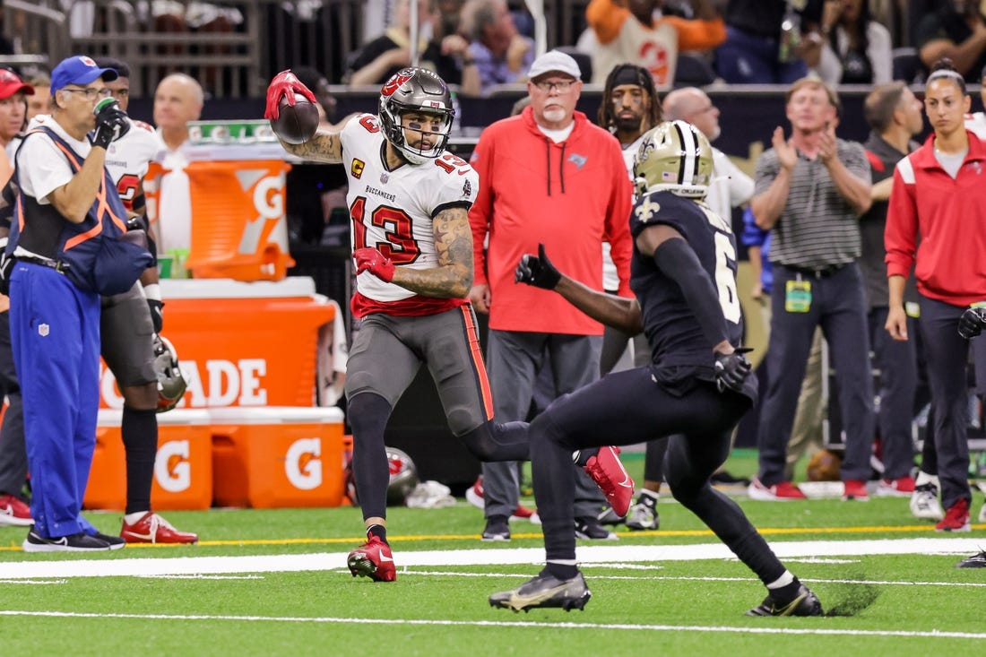Sep 18, 2022; New Orleans, Louisiana, USA;  Tampa Bay Buccaneers wide receiver Mike Evans (13) is shoved out of bounds by New Orleans Saints safety Justin Evans (30) and safety Marcus Maye (6) during the first half at Caesars Superdome. Mandatory Credit: Stephen Lew-USA TODAY Sports
