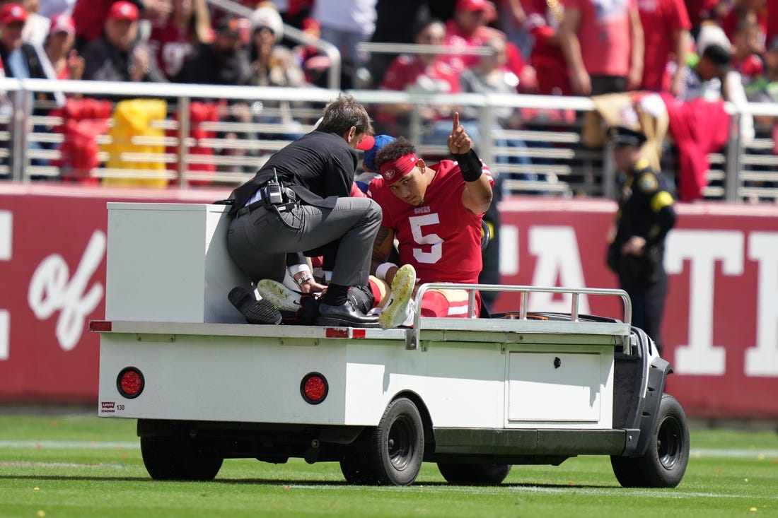 September 18, 2022; Santa Clara, California, USA; San Francisco 49ers quarterback Trey Lance (5) is carted off the field after an injury against the Seattle Seahawks during the first quarter at Levi's Stadium. Mandatory Credit: Kyle Terada-USA TODAY Sports