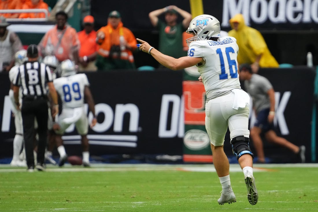 Sep 24, 2022; Miami Gardens, Florida, USA; Middle Tennessee Blue Raiders quarterback Chase Cunningham (16) celebrates after throwing a touchdown pass against the Miami Hurricanes during the first half at Hard Rock Stadium. Mandatory Credit: Jasen Vinlove-USA TODAY Sports
