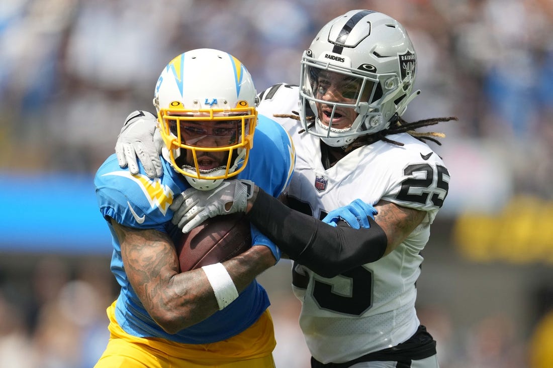 Sep 11, 2022; Inglewood, California, USA; Los Angeles Chargers wide receiver Keenan Allen (13) and Las Vegas Raiders safety Tre'von Moehrig (25) in the first half at SoFi Stadium. Mandatory Credit: Kirby Lee-USA TODAY Sports