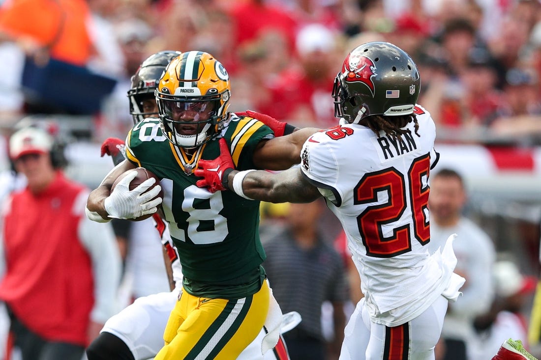 Sep 25, 2022; Tampa, Florida, USA;  Green Bay Packers wide receiver Randall Cobb (18) stiff arms Tampa Bay Buccaneers safety Logan Ryan (26) in the second quarter at Raymond James Stadium. Mandatory Credit: Nathan Ray Seebeck-USA TODAY Sports