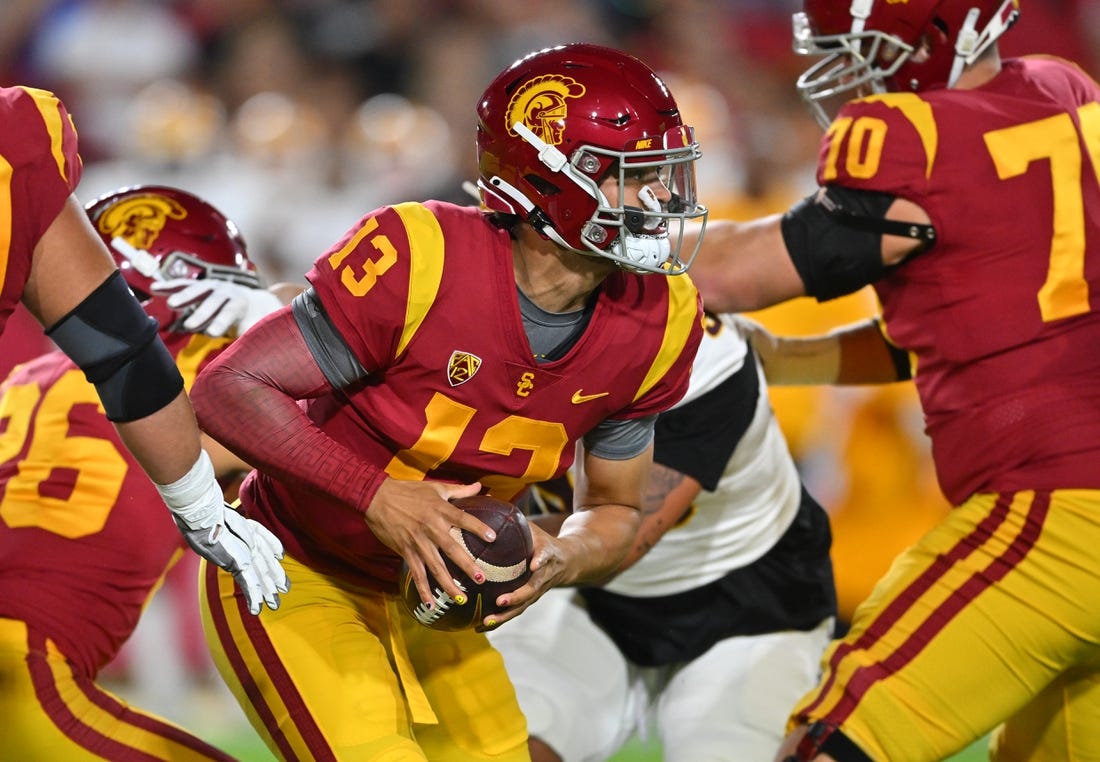 Oct 1, 2022; Los Angeles, California, USA;  USC Trojans quarterback Caleb Williams (13) recovers a fumbled snap and runs for a first down against the Arizona State Sun Devils in the first half at United Airlines Field at the Los Angeles Memorial Coliseum. Mandatory Credit: Jayne Kamin-Oncea-USA TODAY Sports
