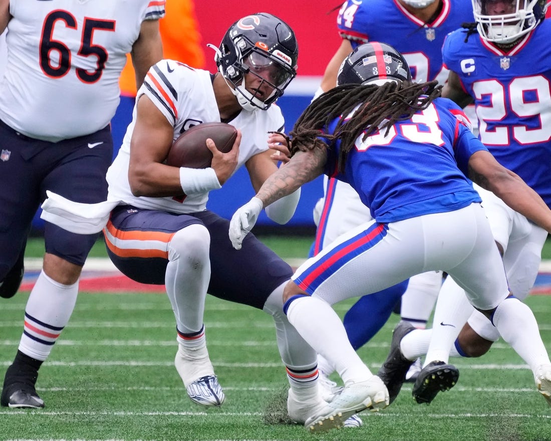 Oct 2, 2022; East Rutherford, New Jersey, USA; Chicago Bears quarterback Justin Fields (1) runs with the ball for a first down against the New York Giants during the first half at MetLife Stadium. Mandatory Credit: Robert Deutsch-USA TODAY Sports