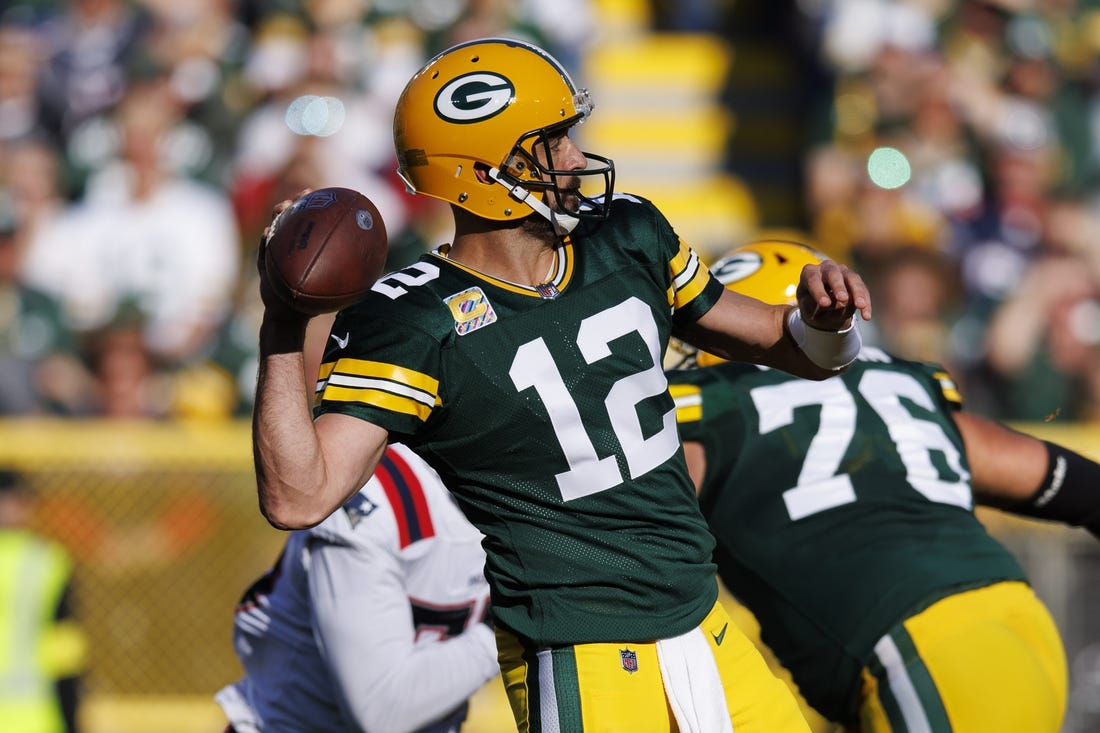 Oct 2, 2022; Green Bay, Wisconsin, USA;  Green Bay Packers quarterback Aaron Rodgers (12) throws a pass during the second quarter against the New England Patriots at Lambeau Field. Mandatory Credit: Jeff Hanisch-USA TODAY Sports