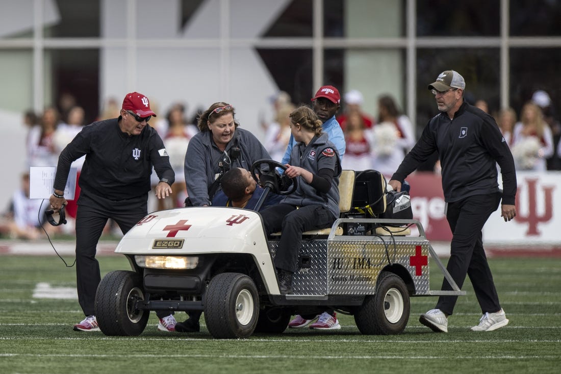 Oct 8, 2022; Bloomington, Indiana, USA;  Indiana Hoosiers head coach Tom Allen wishes Michigan Wolverines RB coach Mike Hart well as he is pulled off the field on a stretcher with an injury during the first quarter at Memorial Stadium. Mandatory Credit: Marc Lebryk-USA TODAY Sports