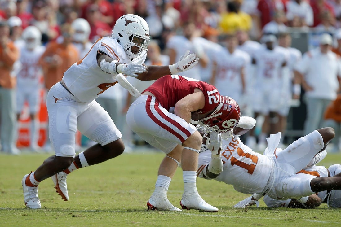 Oklahoma Sooners wide receiver Drake Stoops (12) is brought down by Texas Longhorns defensive back Austin Jordan (4) and Texas Longhorns defensive back Anthony Cook (11) during the Red River Showdown college football game between the University of Oklahoma (OU) and Texas at the Cotton Bowl in Dallas, Saturday, Oct. 8, 2022.

Lx16259