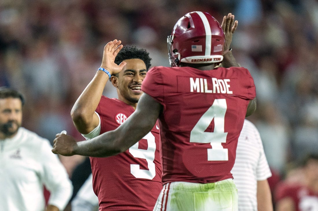 Oct 8, 2022; Tuscaloosa, Alabama, USA; Alabama Crimson Tide quarterback Jalen Milroe (4) celebrates with quarterback Bryce Young (9) after scoring a touchdown against the Texas A&M Aggies during the first half at Bryant-Denny Stadium. Mandatory Credit: Marvin Gentry-USA TODAY Sports