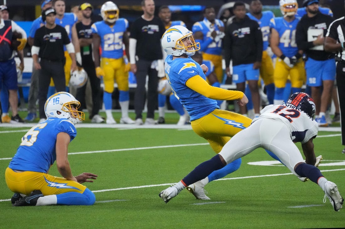 Oct 17, 2022; Inglewood, California, USA; Los Angeles Chargers place kicker Dustin Hopkins (6) kicks a 39-yard fielg goal out of the hold of punter JK Scott (16) in overtime against the Denver Broncos at SoFi Stadium. Mandatory Credit: Kirby Lee-USA TODAY Sports