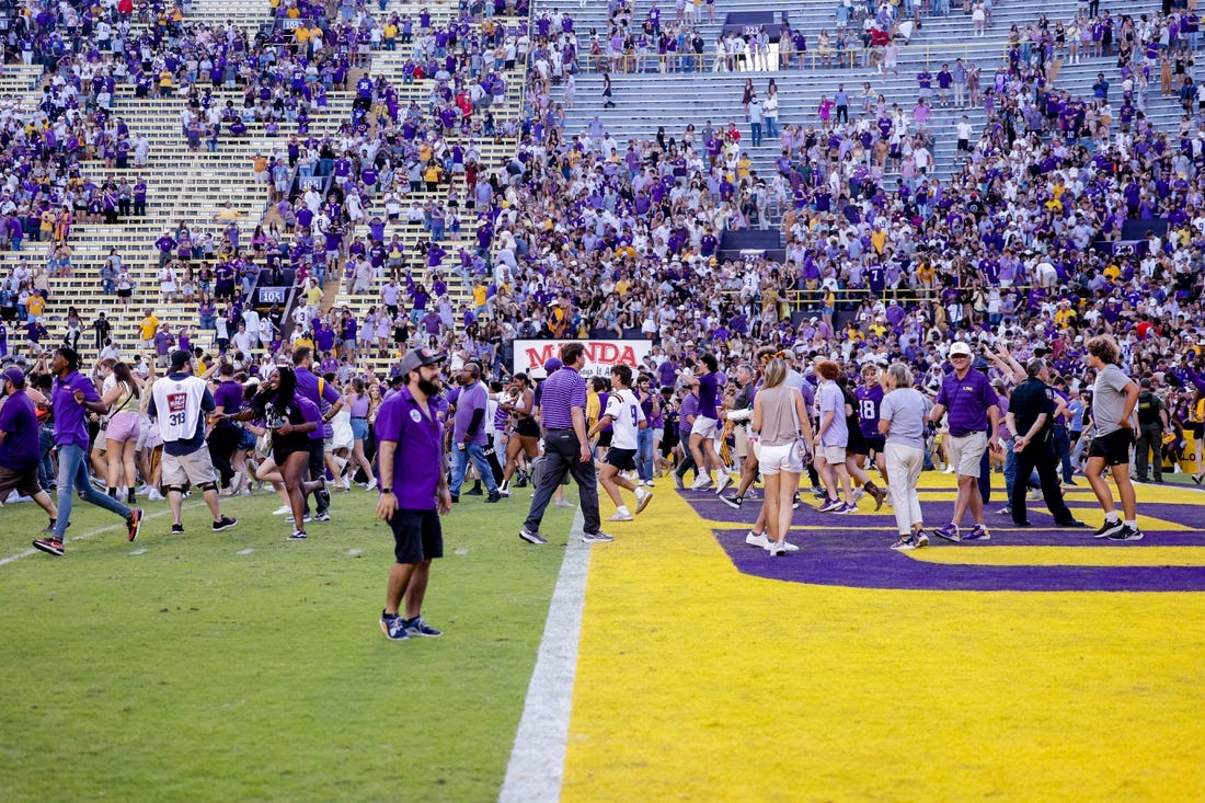 Oct 22, 2022; Baton Rouge, Louisiana, USA; LSU Tigers fans storm the field after LSU defeated the Mississippi Rebels at Tiger Stadium. Mandatory Credit: Stephen Lew-USA TODAY Sports