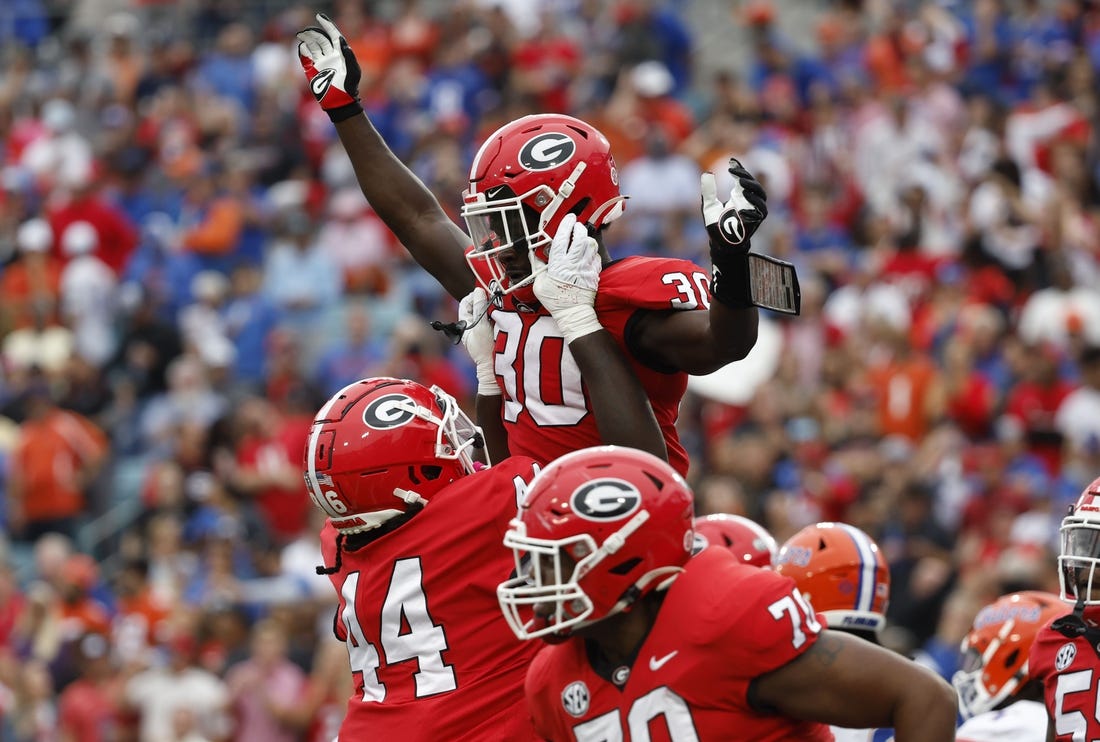 Oct 29, 2022; Jacksonville, Florida, USA; Georgia Bulldogs running back Daijun Edwards (30) is congratulated after he scores a touchdown against the Florida Gators during the first quarter at TIAA Bank Field. Mandatory Credit: Kim Klement-USA TODAY Sports