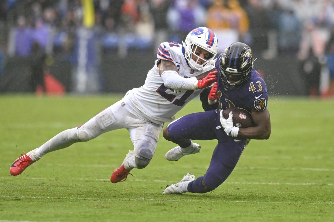 Oct 2, 2022; Baltimore, Maryland, USA;  Baltimore Ravens running back Justice Hill (43) is tackled by Buffalo Bills safety Jordan Poyer (21) during the second half at M&T Bank Stadium. Mandatory Credit: Tommy Gilligan-USA TODAY Sports