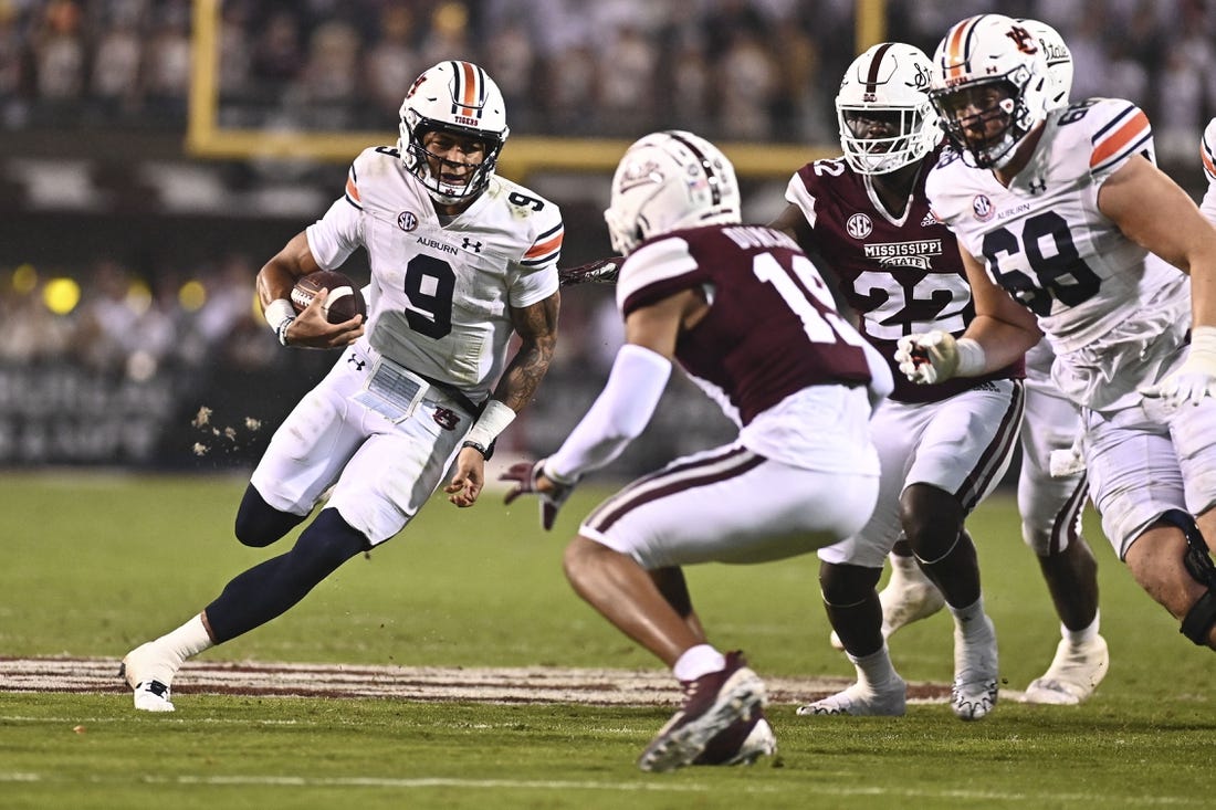 Nov 5, 2022; Starkville, Mississippi, USA; Auburn Tigers quarterback Robby Ashford (9) is defended by Mississippi State Bulldogs safety Collin Duncan (19) during the second quarter at Davis Wade Stadium at Scott Field. Mandatory Credit: Matt Bush-USA TODAY Sports