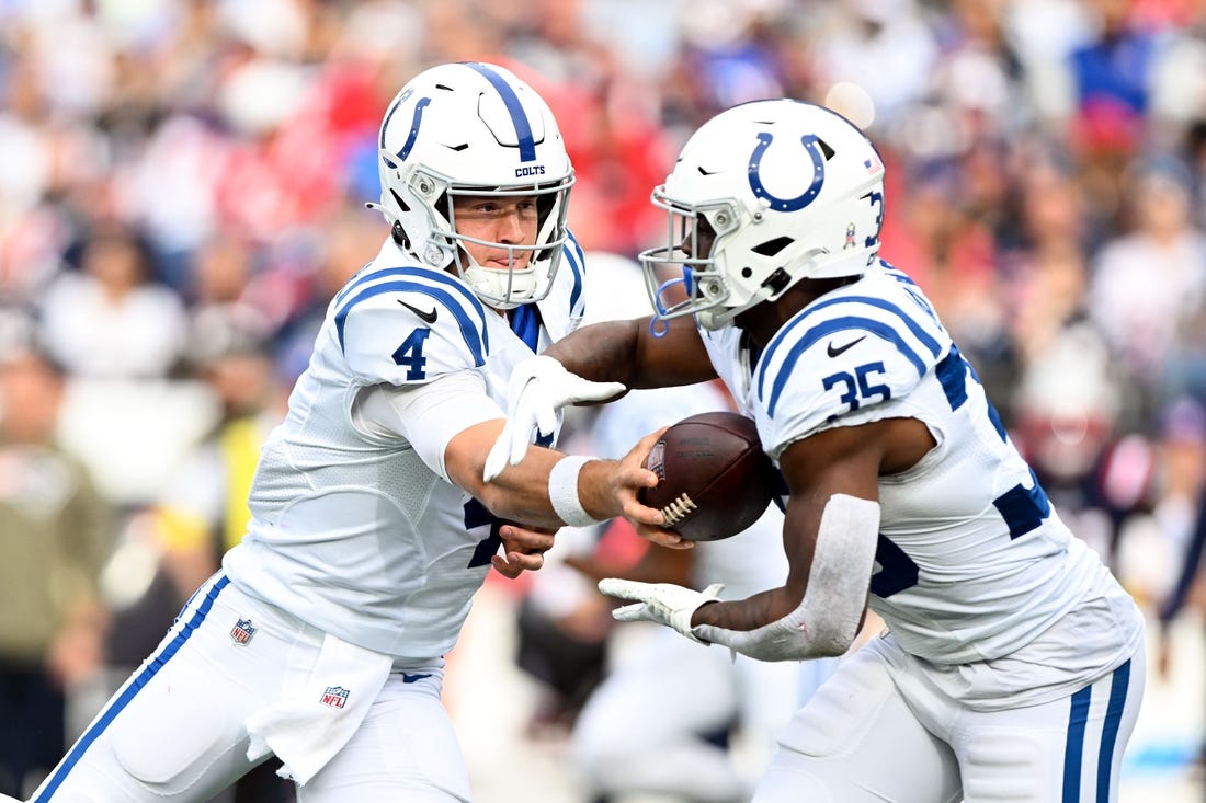 Nov 6, 2022; Foxborough, Massachusetts, USA; Indianapolis Colts quarterback Sam Ehlinger (4) hands the ball off to running back Deon Jackson (35) during the first half at Gillette Stadium. Mandatory Credit: Brian Fluharty-USA TODAY Sports