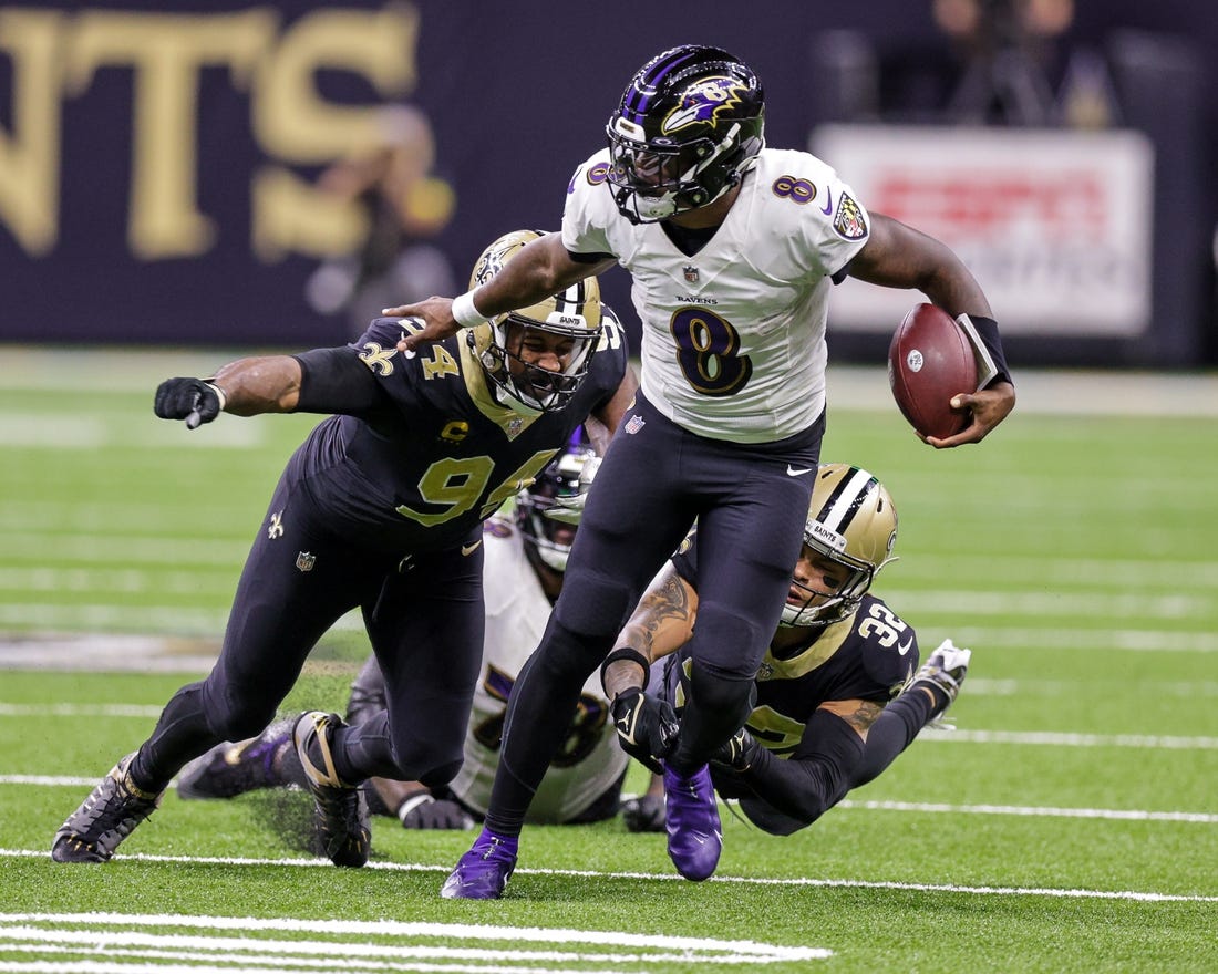 fNov 7, 2022; New Orleans, Louisiana, USA;  Baltimore Ravens quarterback Lamar Jackson (8) scrambles away from New Orleans Saints defensive end Cameron Jordan (94) and safety Tyrann Mathieu (32) during the second half at Caesars Superdome. Mandatory Credit: Stephen Lew-USA TODAY Sports