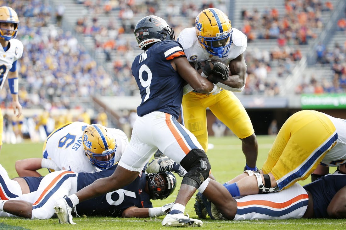 Nov 12, 2022; Charlottesville, Virginia, USA; Pittsburgh Panthers running back Israel Abanikanda (2) carries the ball to score a touchdown as Virginia Cavaliers defensive back Coen King (9) defends during the first half at Scott Stadium. Mandatory Credit: Amber Searls-USA TODAY Sports