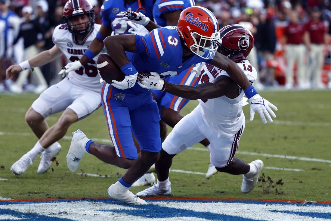 Nov 12, 2022; Gainesville, Florida, USA; South Carolina Gamecocks wide receiver Jalen Brooks (13) causes Florida Gators wide receiver Xzavier Henderson (3) to fumble the ball on special teams during the first quarter at Ben Hill Griffin Stadium. Mandatory Credit: Kim Klement-USA TODAY Sports