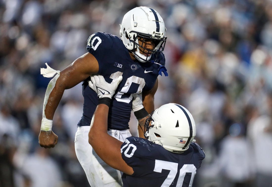 Nov 12, 2022; University Park, Pennsylvania, USA; Penn State Nittany Lions running back Nicholas Singleton (10) celebrates with offensive linesman Juice Scruggs (70) after scoring a touchdown during the second quarter against the Maryland Terrapins at Beaver Stadium. Penn State defeated Maryland 30-0. Mandatory Credit: Matthew OHaren-USA TODAY Sports