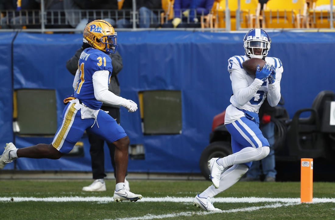 Nov 19, 2022; Pittsburgh, Pennsylvania, USA;  Duke Blue Devils wide receiver Jalon Calhoun (5) catches a touchdown pass behind Pittsburgh Panthers defensive back Erick Hallett II (31) during the first quarter at Acrisure Stadium. Mandatory Credit: Charles LeClaire-USA TODAY Sports