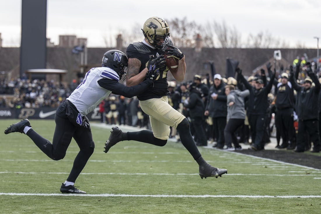 Nov 19, 2022; West Lafayette, Indiana, USA;  Purdue Boilermakers tight end Payne Durham (87) catches a pass that results in a touchdown against Northwestern Wildcats defensive back Jeremiah Lewis (9) during the second quarter  at Ross-Ade Stadium. Mandatory Credit: Marc Lebryk-USA TODAY Sports