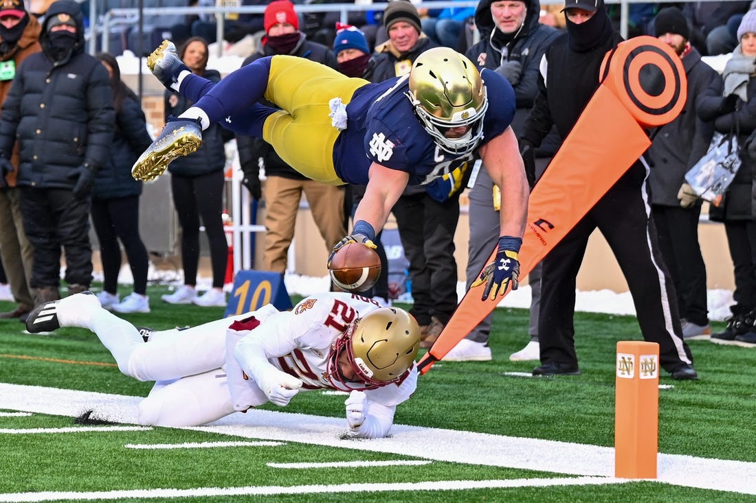 Nov 19, 2022; South Bend, Indiana, USA; Notre Dame Fighting Irish tight end Michael Mayer (87) dives for the pylon as Boston College Eagles defensive back Josh DeBerry (21) defends in the first quarter at Notre Dame Stadium. Mandatory Credit: Matt Cashore-USA TODAY Sports