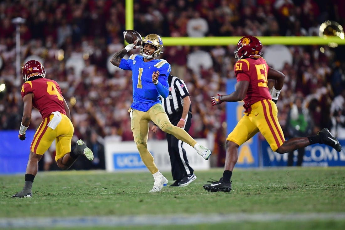 Nov 19, 2022; Pasadena, California, USA; UCLA Bruins quarterback Dorian Thompson-Robinson (1) throws as Southern California Trojans defensive back Max Williams (4) and defensive lineman Solomon Byrd (51) move in during the second half at the Rose Bowl. Mandatory Credit: Gary A. Vasquez-USA TODAY Sports