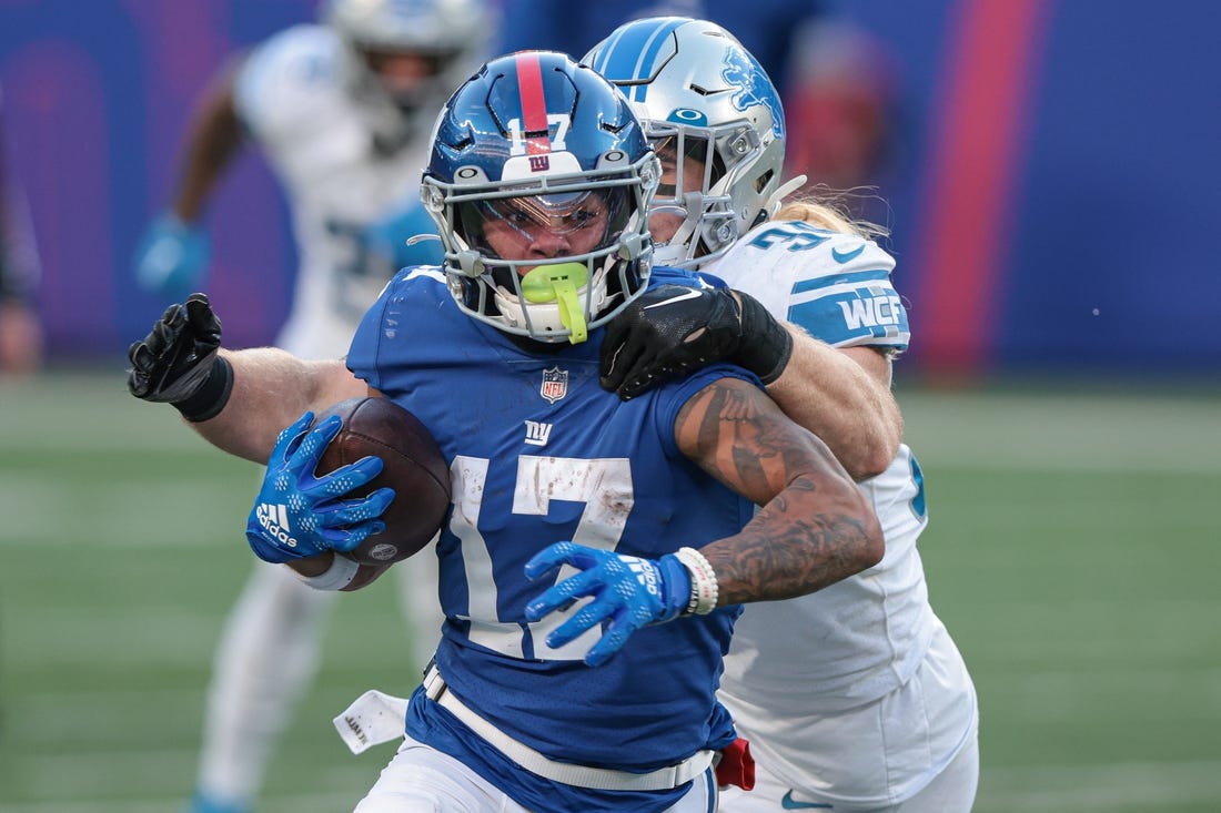 Nov 20, 2022; East Rutherford, New Jersey, USA; New York Giants wide receiver Wan'Dale Robinson (17) breaks a tackle by Detroit Lions linebacker Alex Anzalone (34) during the second half at MetLife Stadium. Mandatory Credit: Vincent Carchietta-USA TODAY Sports