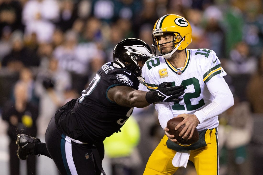 Nov 27, 2022; Philadelphia, Pennsylvania, USA; Green Bay Packers quarterback Aaron Rodgers (12) avoids the tackle attempt of Philadelphia Eagles defensive tackle Javon Hargrave (97) during the first quarter at Lincoln Financial Field. Mandatory Credit: Bill Streicher-USA TODAY Sports