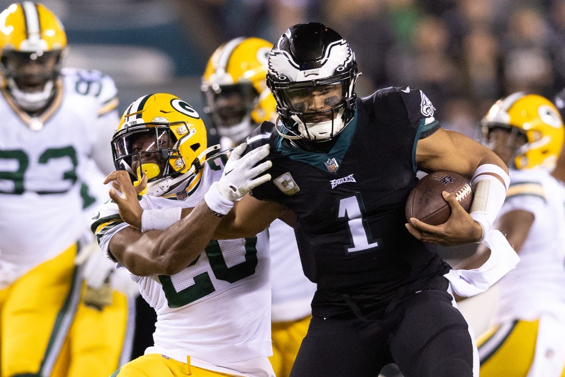 Nov 27, 2022; Philadelphia, Pennsylvania, USA; Philadelphia Eagles quarterback Jalen Hurts (1) runs with the ball against Green Bay Packers safety Rudy Ford (20) during the second quarter at Lincoln Financial Field. Mandatory Credit: Bill Streicher-USA TODAY Sports