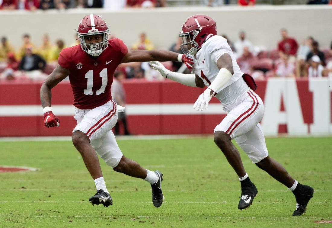 Apr 16, 2022; Tuscaloosa, Alabama, USA;  Crimson wide receiver Traeshon Holden (11) is defended by White defensive back Kool-Aid McKinstry (1) during the A-Day game at Bryant-Denny Stadium. Mandatory Credit: Gary Cosby Jr.-USA TODAY Sports