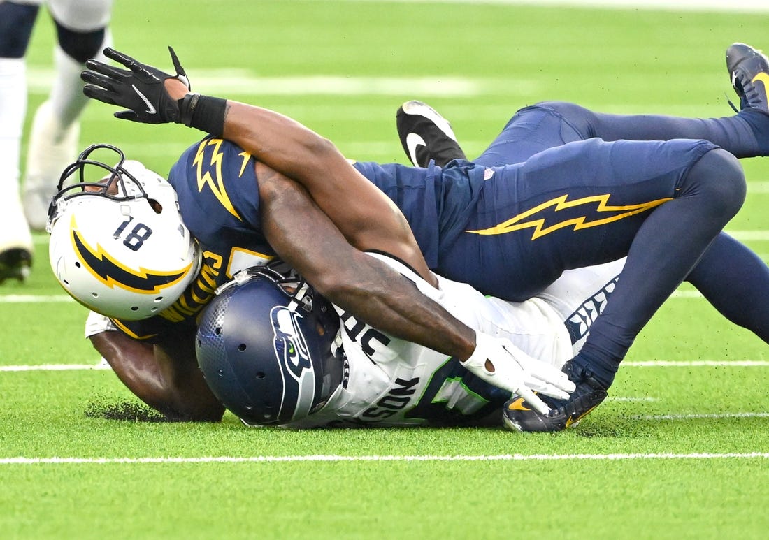 Oct 23, 2022; Inglewood, California, USA;  Los Angeles Chargers wide receiver Mike Williams (81) injured his ankle after he is brought down by Seattle Seahawks cornerback Mike Jackson (30) after a complete pass in the second half at SoFi Stadium. Mandatory Credit: Jayne Kamin-Oncea-USA TODAY Sports